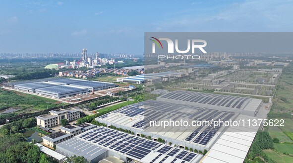 Power technicians are inspecting the operation of rooftop solar photovoltaic modules in Chuzhou, China, on June 30, 2024. 