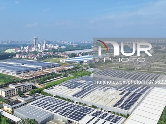 Power technicians are inspecting the operation of rooftop solar photovoltaic modules in Chuzhou, China, on June 30, 2024. (