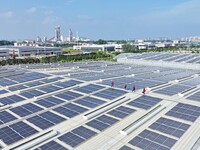 Power technicians are inspecting the operation of rooftop solar photovoltaic modules in Chuzhou, China, on June 30, 2024. (