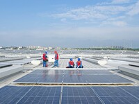 Power technicians are inspecting the operation of rooftop solar photovoltaic modules in Chuzhou, China, on June 30, 2024. (