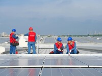 Power technicians are inspecting the operation of rooftop solar photovoltaic modules in Chuzhou, China, on June 30, 2024. (