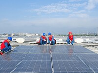 Power technicians are inspecting the operation of rooftop solar photovoltaic modules in Chuzhou, China, on June 30, 2024. (