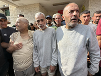 Palestinian men who are being detained by Israeli forces are arriving after their release for a check-up at the Al-Aqsa Martyrs Hospital in...