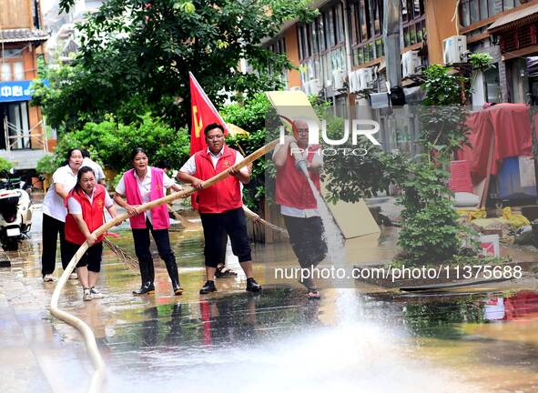 Villagers are removing silt formed by heavy rain in Congjiang county, Qiandongnan Miao and Dong autonomous prefecture, Southwest China's Gui...