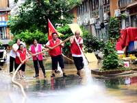 Villagers are removing silt formed by heavy rain in Congjiang county, Qiandongnan Miao and Dong autonomous prefecture, Southwest China's Gui...