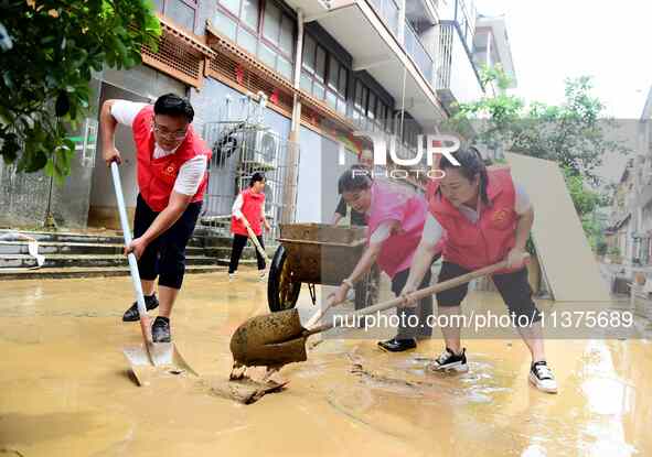 Villagers are removing silt formed by heavy rain in Congjiang county, Qiandongnan Miao and Dong autonomous prefecture, Southwest China's Gui...