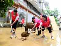 Villagers are removing silt formed by heavy rain in Congjiang county, Qiandongnan Miao and Dong autonomous prefecture, Southwest China's Gui...