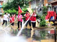 Villagers are removing silt formed by heavy rain in Congjiang county, Qiandongnan Miao and Dong autonomous prefecture, Southwest China's Gui...