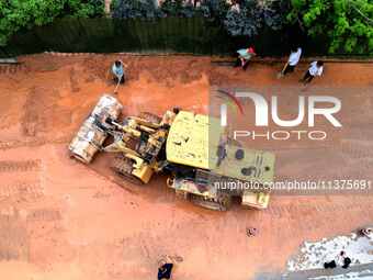 Villagers are removing silt formed by heavy rain in Congjiang county, Qiandongnan Miao and Dong autonomous prefecture, Southwest China's Gui...