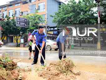 Villagers are removing silt formed by heavy rain in Congjiang county, Qiandongnan Miao and Dong autonomous prefecture, Southwest China's Gui...