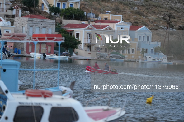 People are enjoying the warm weather this morning in Symi, Greece, on July 1, 2024. 