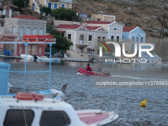 People are enjoying the warm weather this morning in Symi, Greece, on July 1, 2024. (