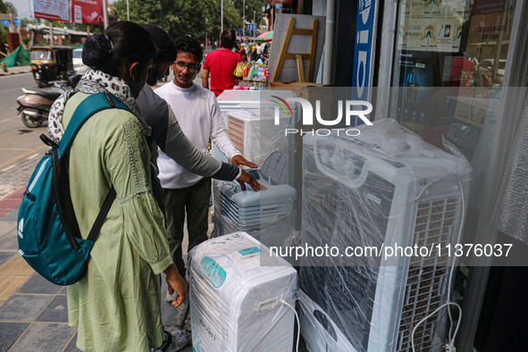 People are checking water cooling fans on a hot summer day in Srinagar, Jammu And Kashmir, on July 01, 2024. 