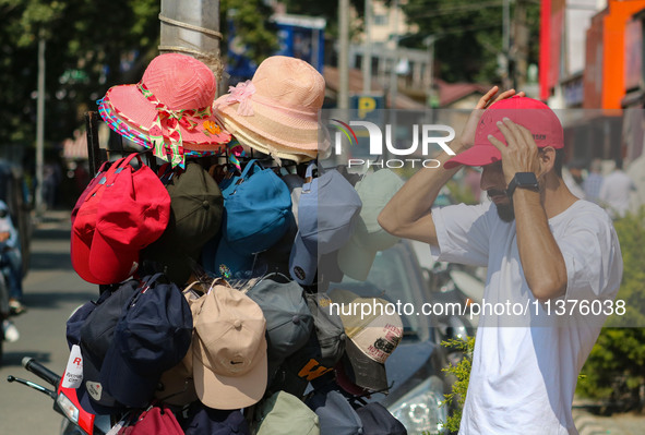 A man is wearing a cap on a hot summer day in Srinagar, Jammu And Kashmir, on July 01, 2024. 