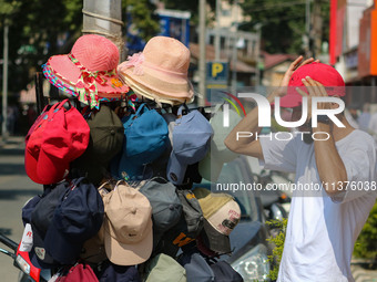 A man is wearing a cap on a hot summer day in Srinagar, Jammu And Kashmir, on July 01, 2024. (