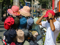 A man is wearing a cap on a hot summer day in Srinagar, Jammu And Kashmir, on July 01, 2024. (