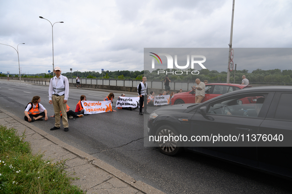 Climate activists from the Last Generation (Ostatnia Generacja) are blocking a main road to protest against the inaction of politicians towa...