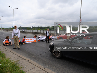 Climate activists from the Last Generation (Ostatnia Generacja) are blocking a main road to protest against the inaction of politicians towa...