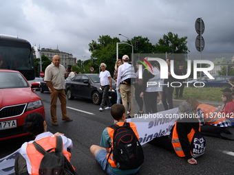 Climate activists from the Last Generation (Ostatnia Generacja) are blocking a main road to protest against the inaction of politicians towa...