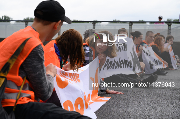 Climate activists from the Last Generation (Ostatnia Generacja) are blocking a main road to protest against the inaction of politicians towa...