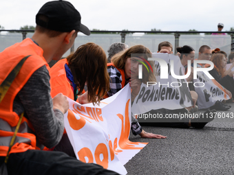 Climate activists from the Last Generation (Ostatnia Generacja) are blocking a main road to protest against the inaction of politicians towa...