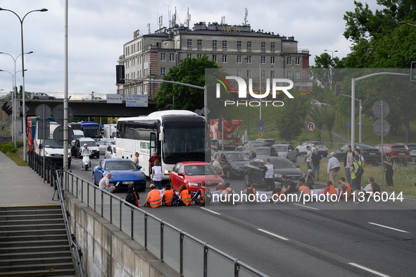 Climate activists from the Last Generation (Ostatnia Generacja) are blocking a main road to protest against the inaction of politicians towa...