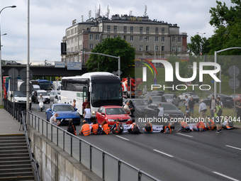 Climate activists from the Last Generation (Ostatnia Generacja) are blocking a main road to protest against the inaction of politicians towa...