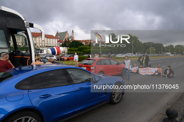 Climate activists from the Last Generation (Ostatnia Generacja) are blocking a main road to protest against the inaction of politicians towa...