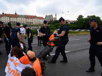 Police officers are detaining climate activists from the Last Generation (Ostatnia Generacja) as they are blocking a main road to protest ag...