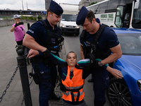 Police officers are detaining climate activists from the Last Generation (Ostatnia Generacja) as they are blocking a main road to protest ag...