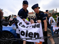 Police officers are detaining climate activists from the Last Generation (Ostatnia Generacja) as they are blocking a main road to protest ag...