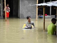 People are shifting their belongings to a safer place following a heavy rainfall in Nagaon District of Assam, India, on July 1, 2024. (