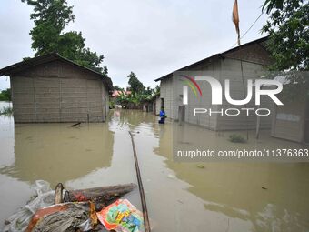 A man is walking through a flooded area in a village in Nagaon District of Assam, India, on July 1, 2024. (