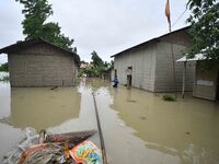 A man is walking through a flooded area in a village in Nagaon District of Assam, India, on July 1, 2024. (