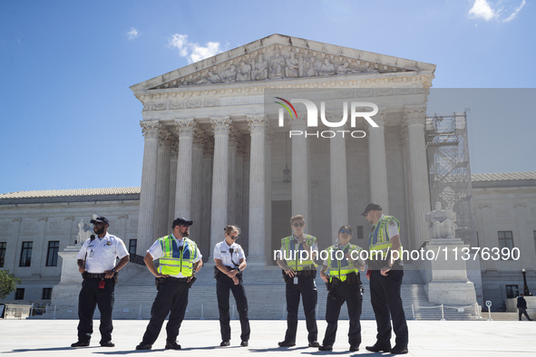 U. S. Supreme Court Police guard the plaza in front of the Court after it issued the last remaining opinions of the term, including a decisi...