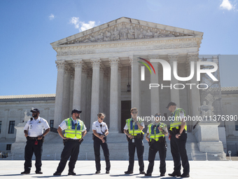 U. S. Supreme Court Police guard the plaza in front of the Court after it issued the last remaining opinions of the term, including a decisi...