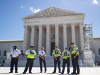 U. S. Supreme Court Police guard the plaza in front of the Court after it issued the last remaining opinions of the term, including a decisi...