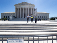 U. S. Supreme Court Police guard the plaza in front of the Court after it issued the last remaining opinions of the term, including a decisi...