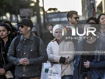 Pedestrians are facing a freezing winter morning on Avenida Paulista in Sao Paulo, on July 01, 2024. (