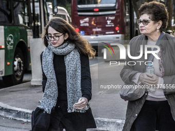 Pedestrians are facing a freezing winter morning on Avenida Paulista in Sao Paulo, on July 01, 2024. (