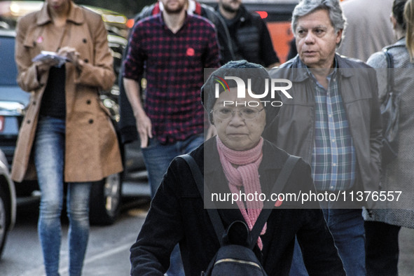 Pedestrians are facing a freezing winter morning on Avenida Paulista in Sao Paulo, on July 01, 2024. 