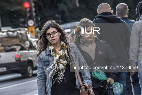 Pedestrians are facing a freezing winter morning on Avenida Paulista in Sao Paulo, on July 01, 2024. 