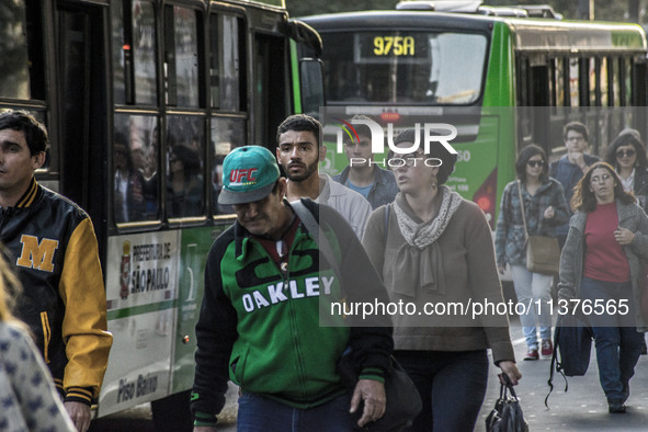 Pedestrians are facing a freezing winter morning on Avenida Paulista in Sao Paulo, on July 01, 2024. 