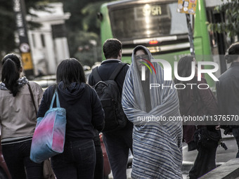 Pedestrians are facing a freezing winter morning on Avenida Paulista in Sao Paulo, on July 01, 2024. (