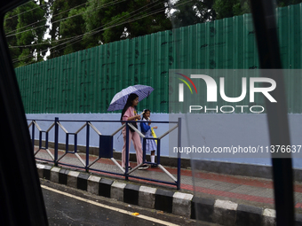 School students are carrying umbrellas during heavy rainfall in Darjeeling, India, on July 1, 2024. Darjeeling is a famous tourist destinati...