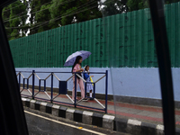 School students are carrying umbrellas during heavy rainfall in Darjeeling, India, on July 1, 2024. Darjeeling is a famous tourist destinati...