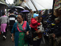 People are being seen in a market area during rainfall in Darjeeling, India, on July 1, 2024. Darjeeling is a famous tourist destination in...