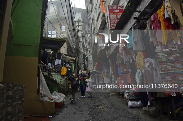 Narrow lanes consisting of essential item shops are being seen during rainfall in Darjeeling, India, on July 1, 2024. Darjeeling is a famous...