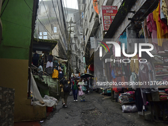 Narrow lanes consisting of essential item shops are being seen during rainfall in Darjeeling, India, on July 1, 2024. Darjeeling is a famous...