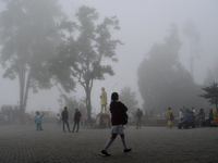 A man is passing through dense cloud on Mall Road in Darjeeling, India, on July 1, 2024. Darjeeling is a famous tourist destination in North...